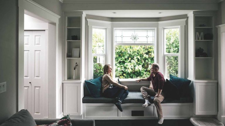 Selling Guide - couple talking at window seat