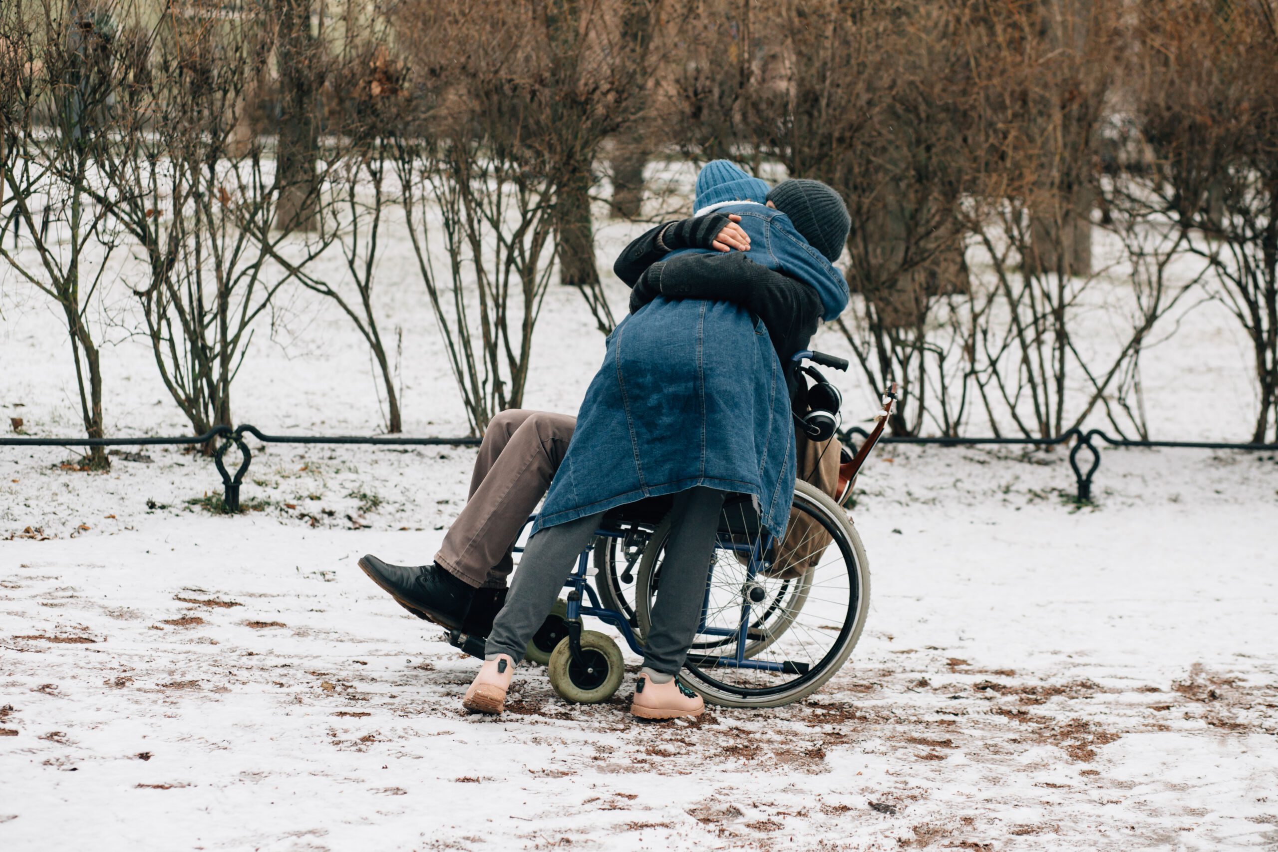 Disabled man embracing  his friend